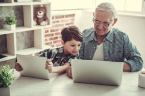 a grandchild and granddad learning about saving