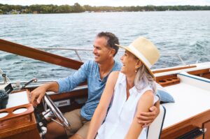 a happy couple on a boat after reaching their retirement goals