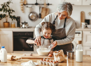 Grand mother and grandchild learning to bake 